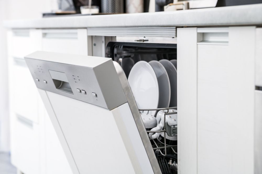 Open Dishwasher With Clean Dishes After Washing — A J Wilcox Air & Electrical in Banora Point, NSW