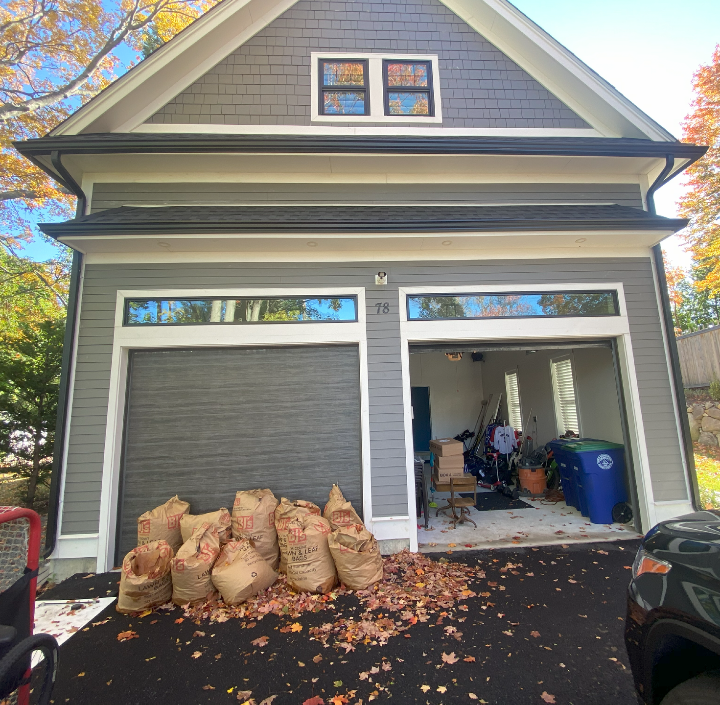 A garage with bags of leaves in front of it
