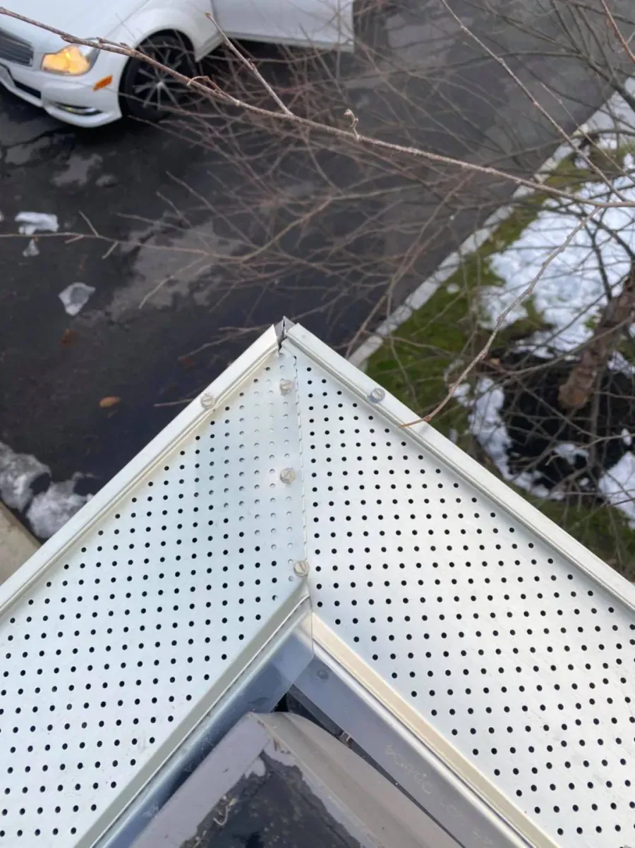 A white car is parked on the side of the road