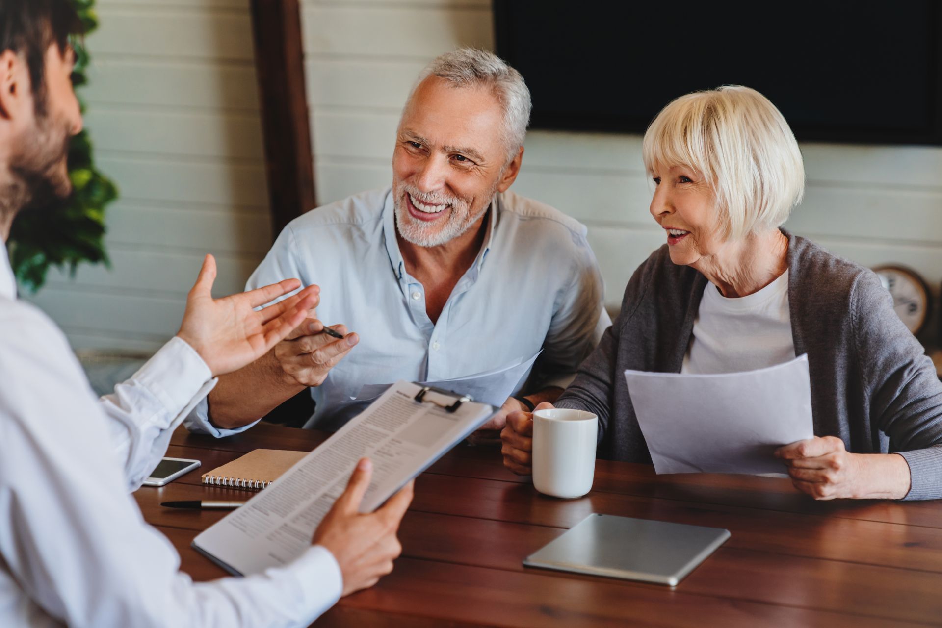 Happy family celebrating with grandfather around dinner table
