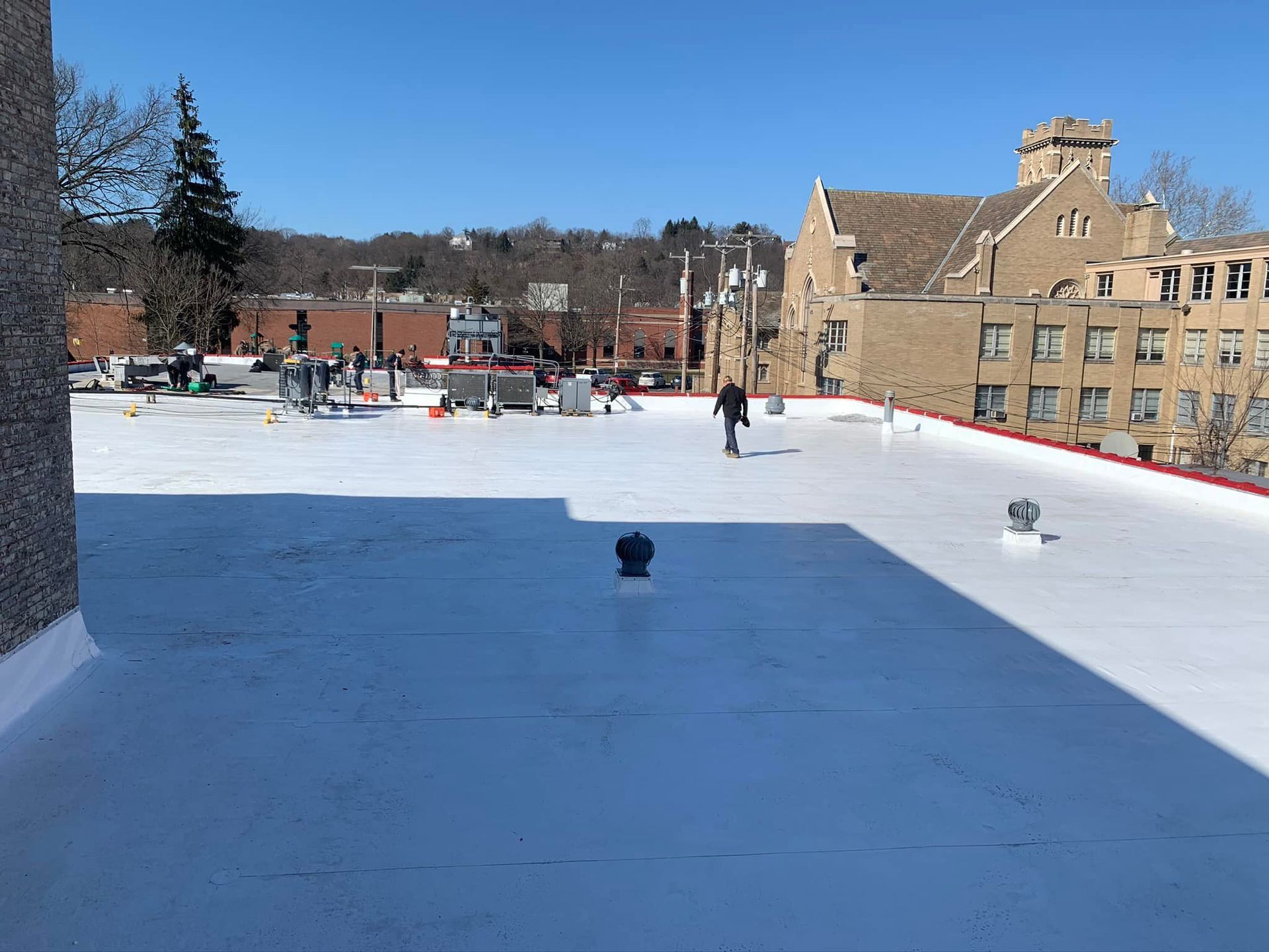 A man is walking on the roof of a building