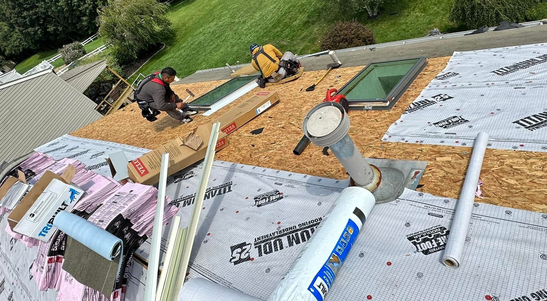 A group of people are working on a roof.