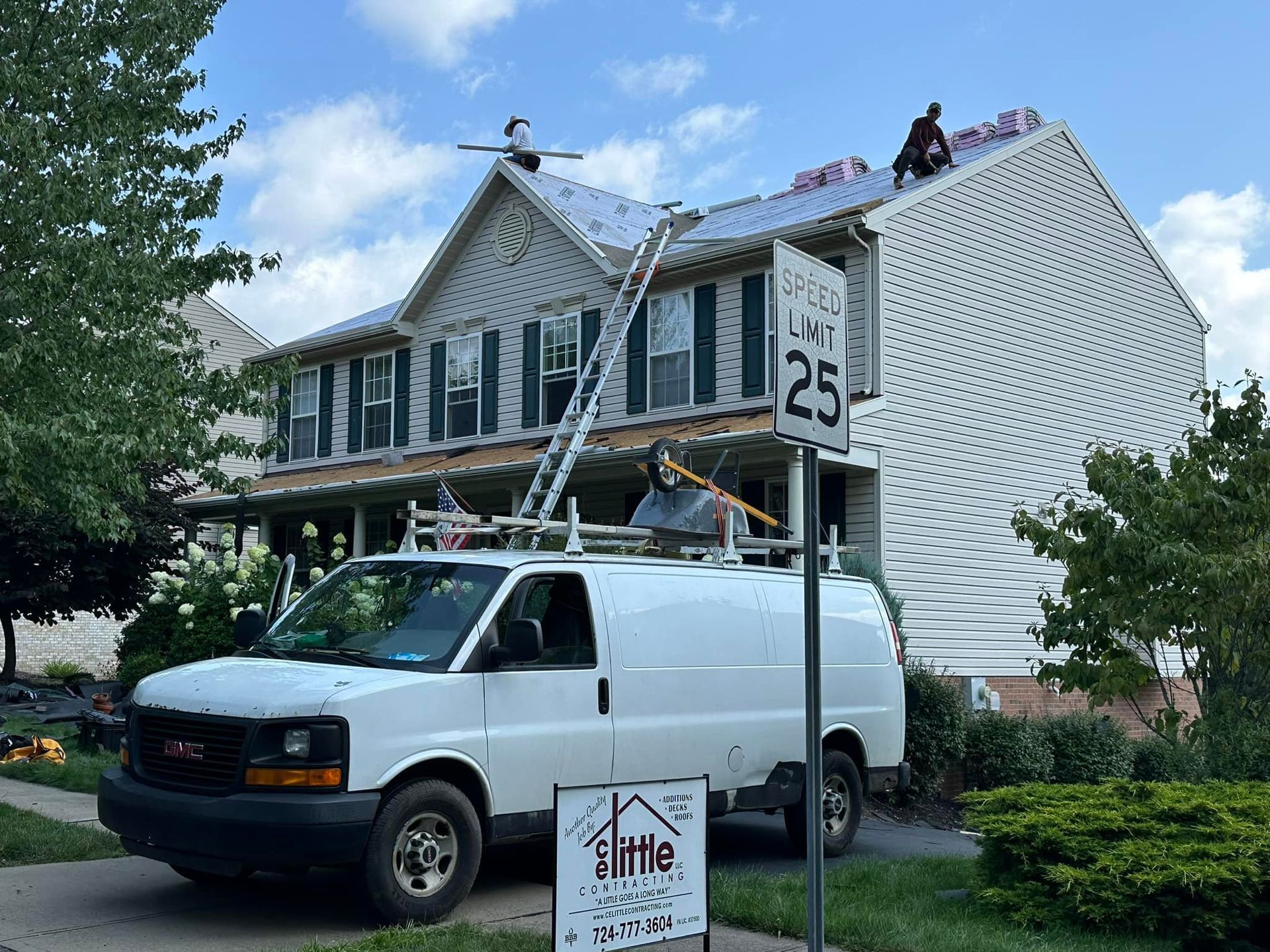 A white van is parked in front of a house.