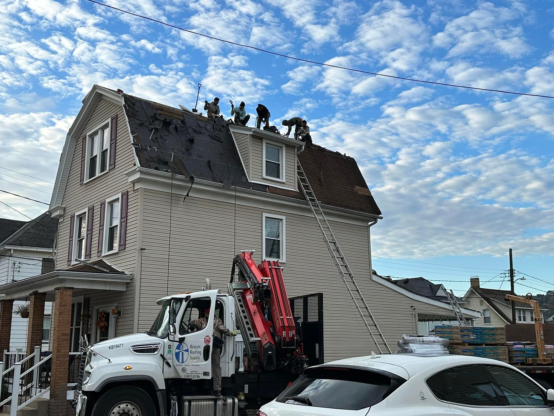 A truck is parked in front of a house that is being remodeled.