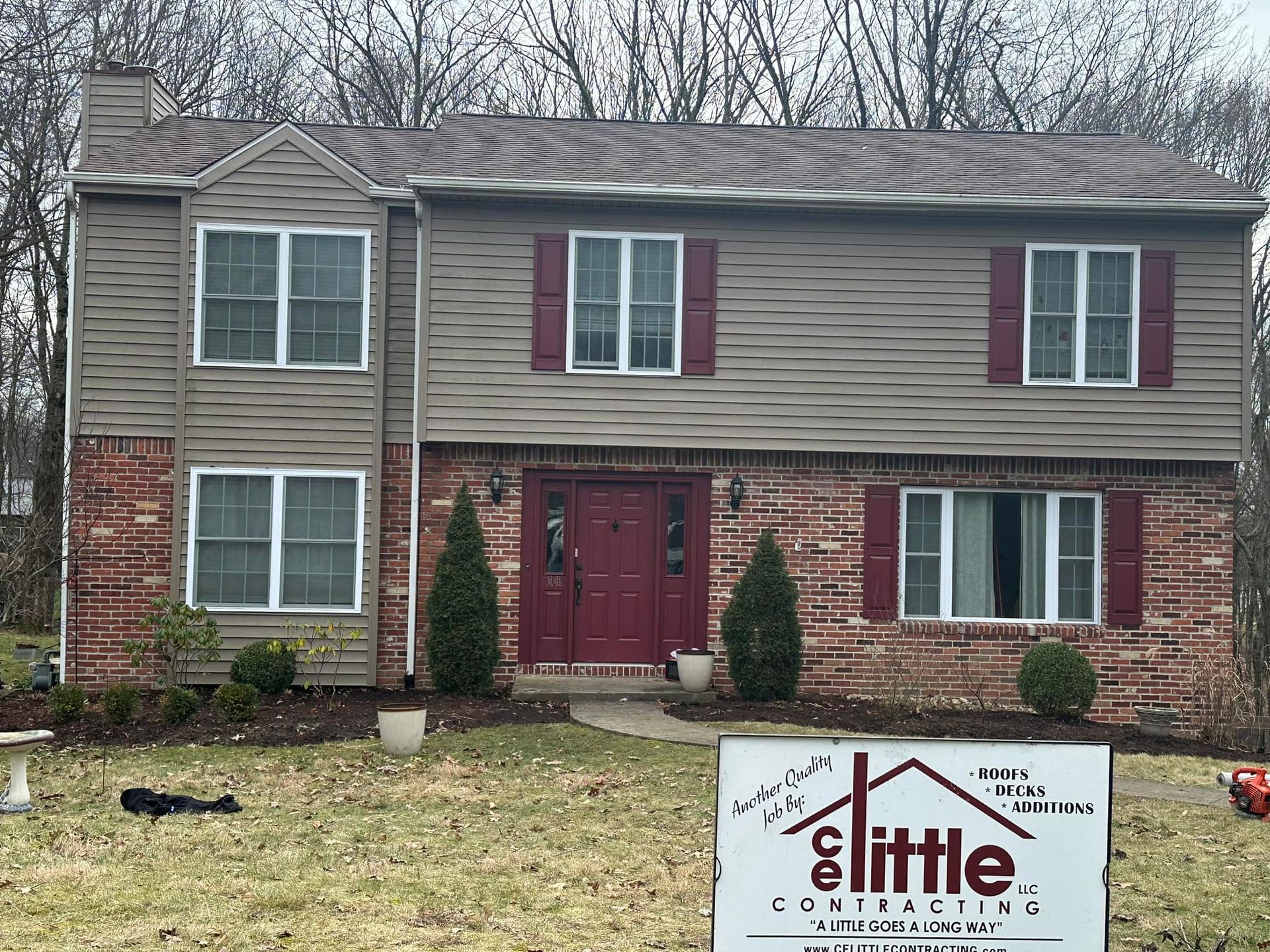 A house with a little construction sign in front of it