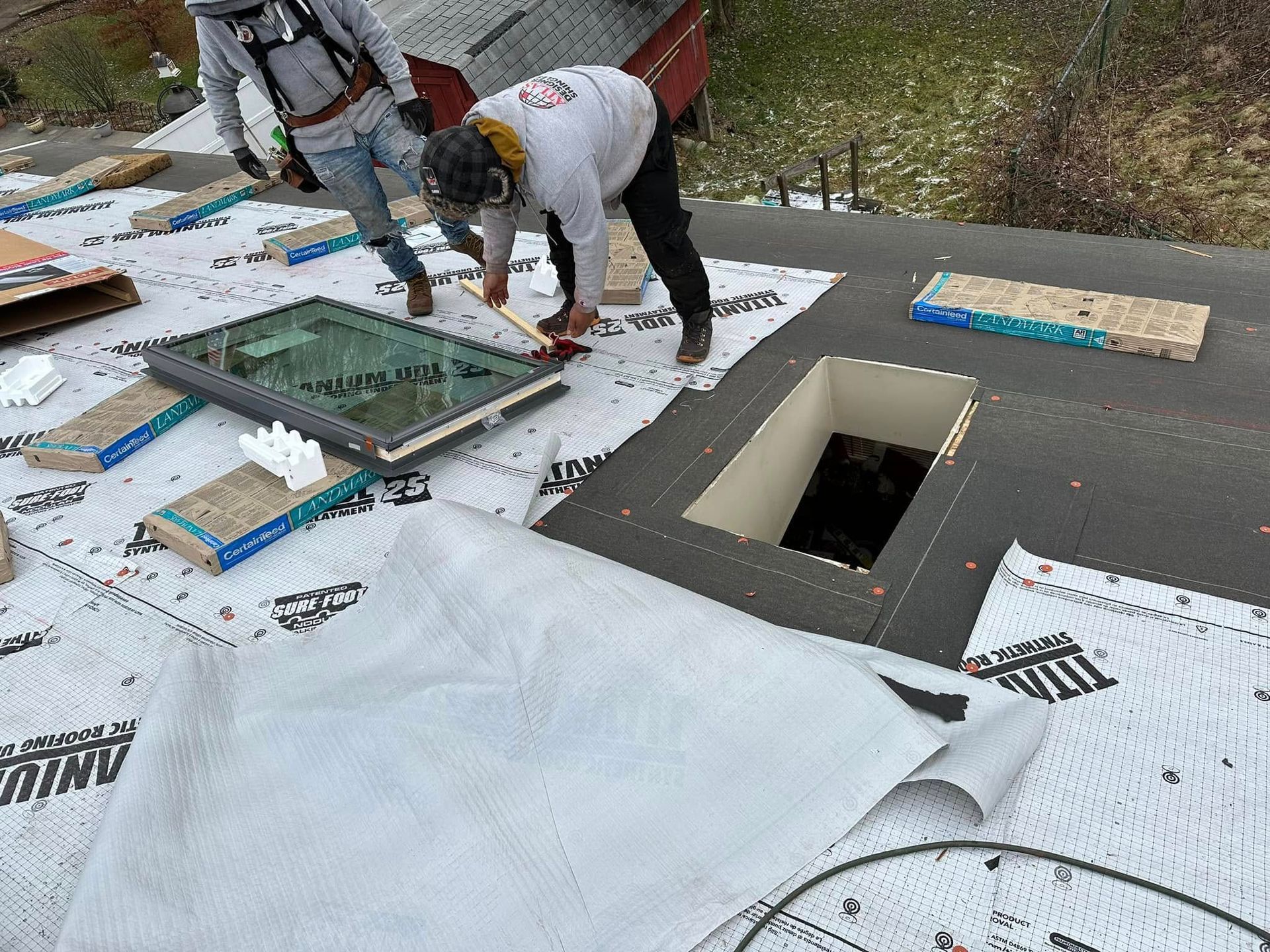 A man is working on a roof with a hole in it.