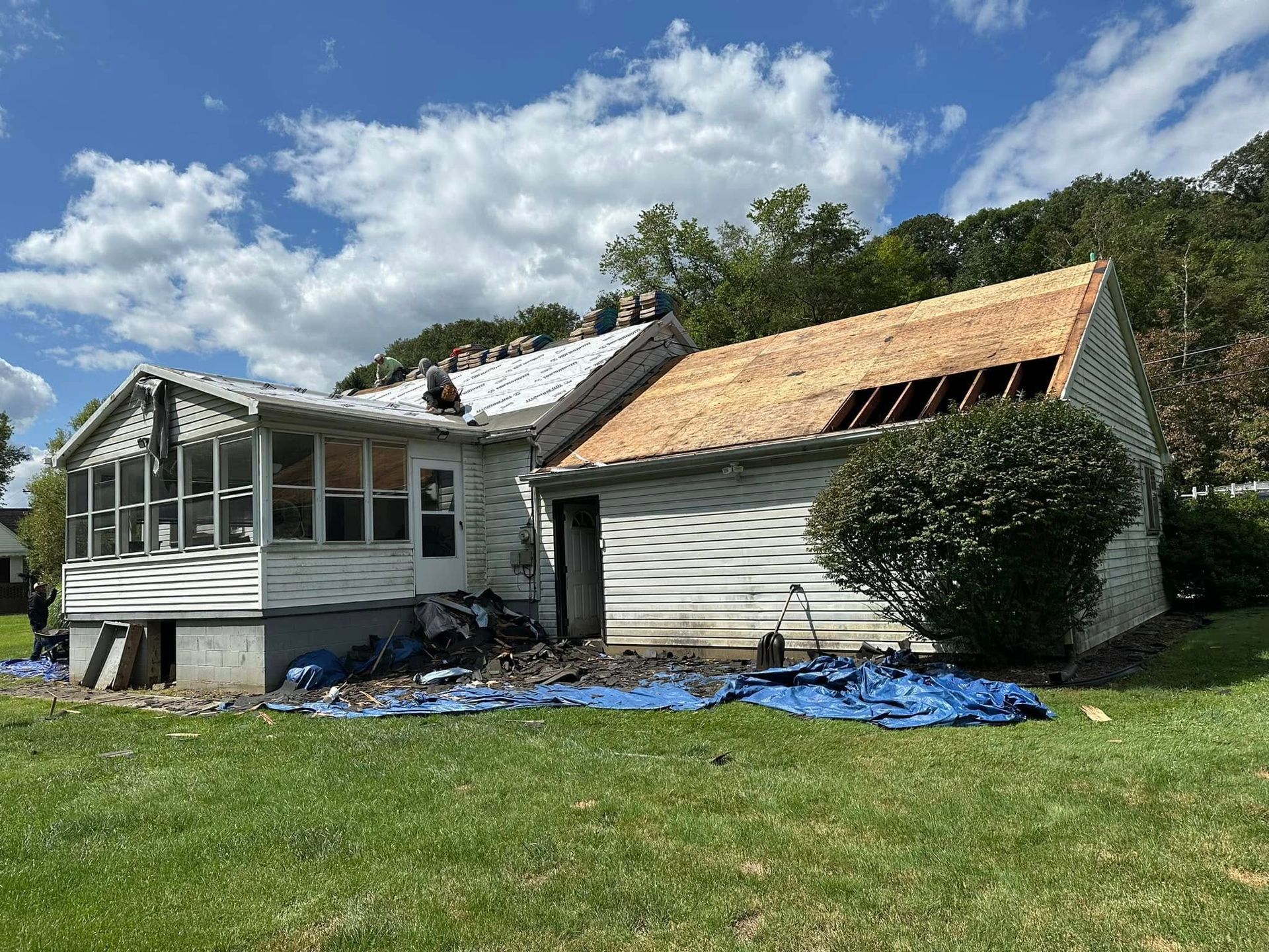 A house with a roof that is being remodeled.