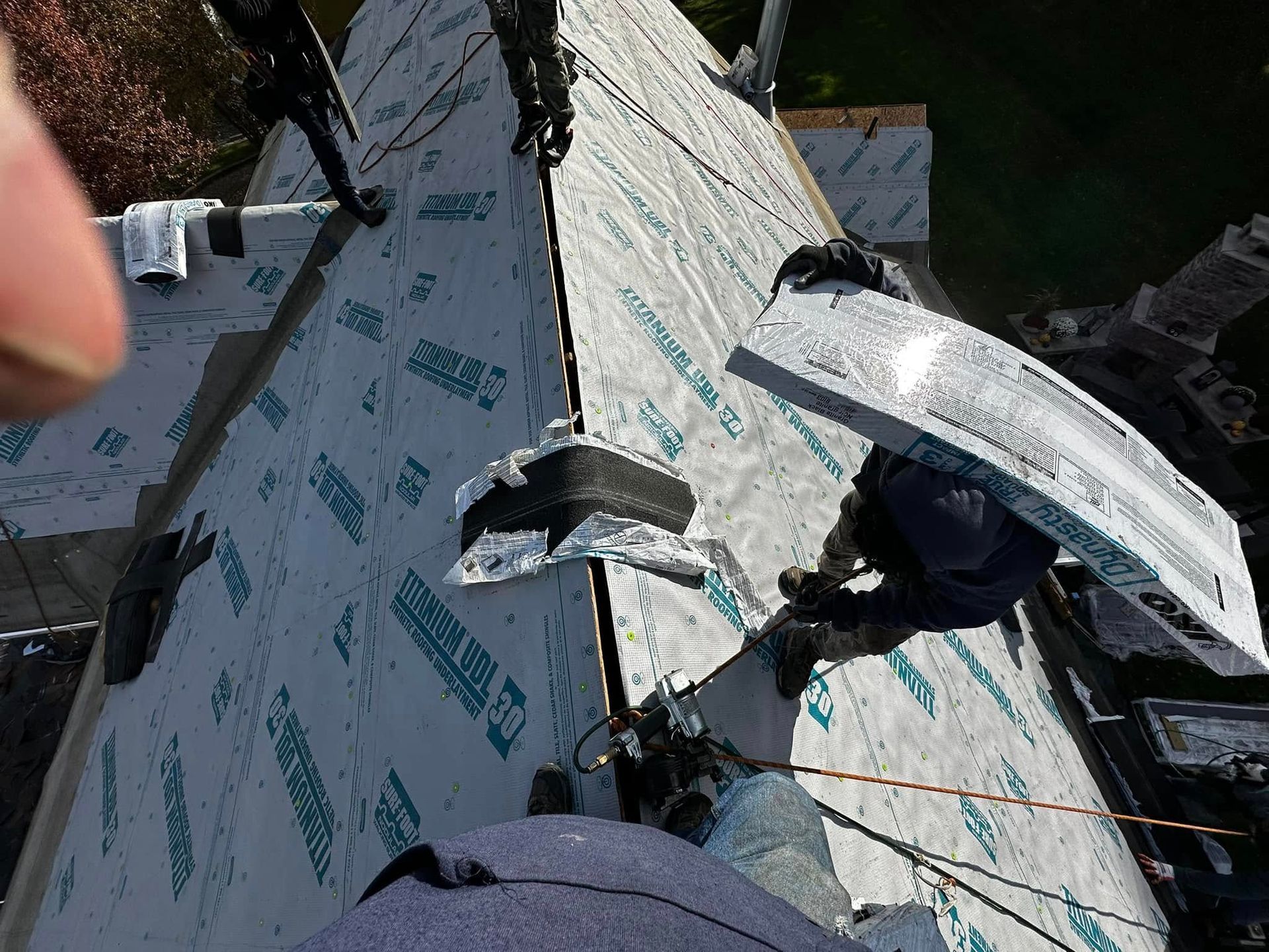 A man is working on the roof of a house.