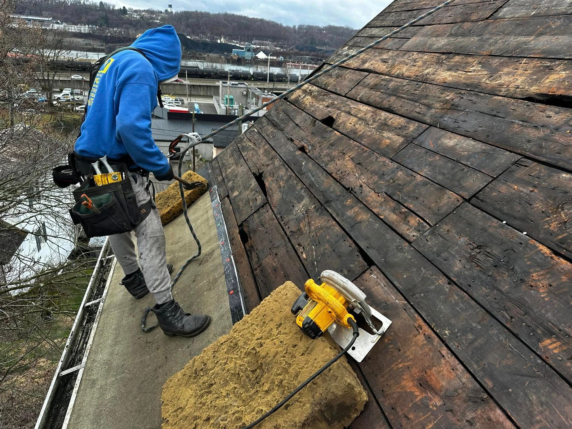 A man is working on the roof of a building.