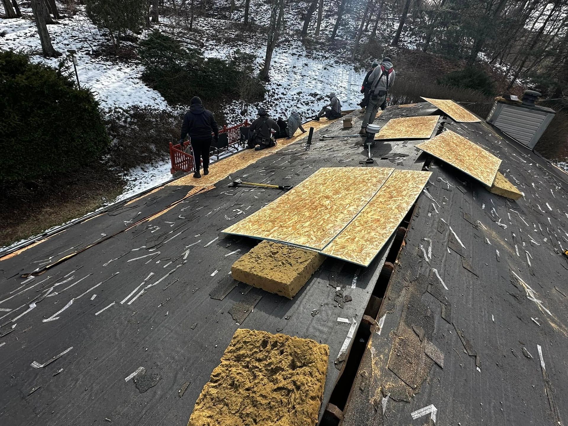 A group of people are working on a roof.