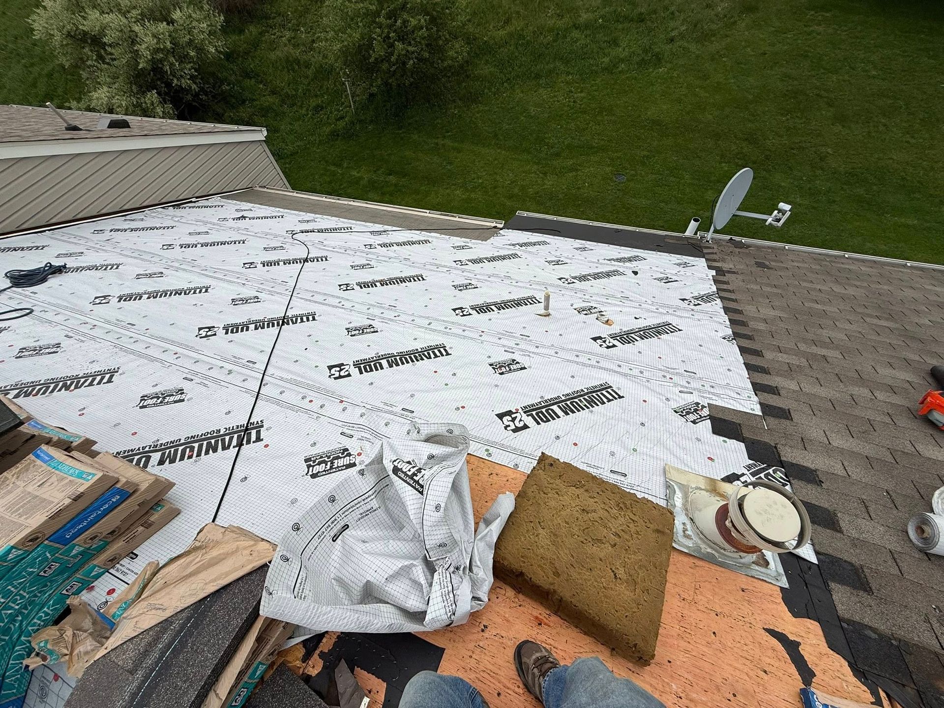 A person is sitting on the roof of a house.