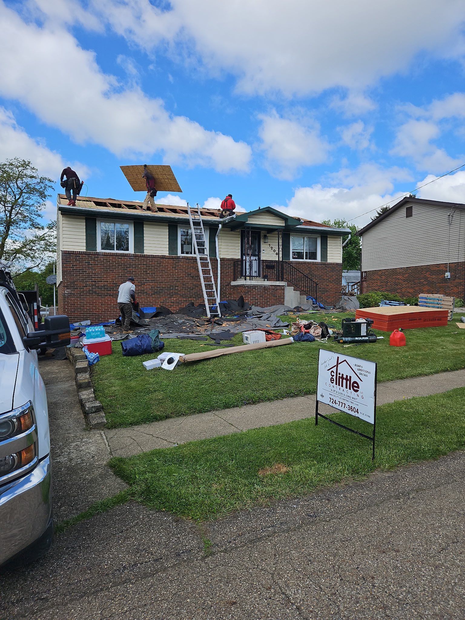 A house is being remodeled with a truck parked in front of it.