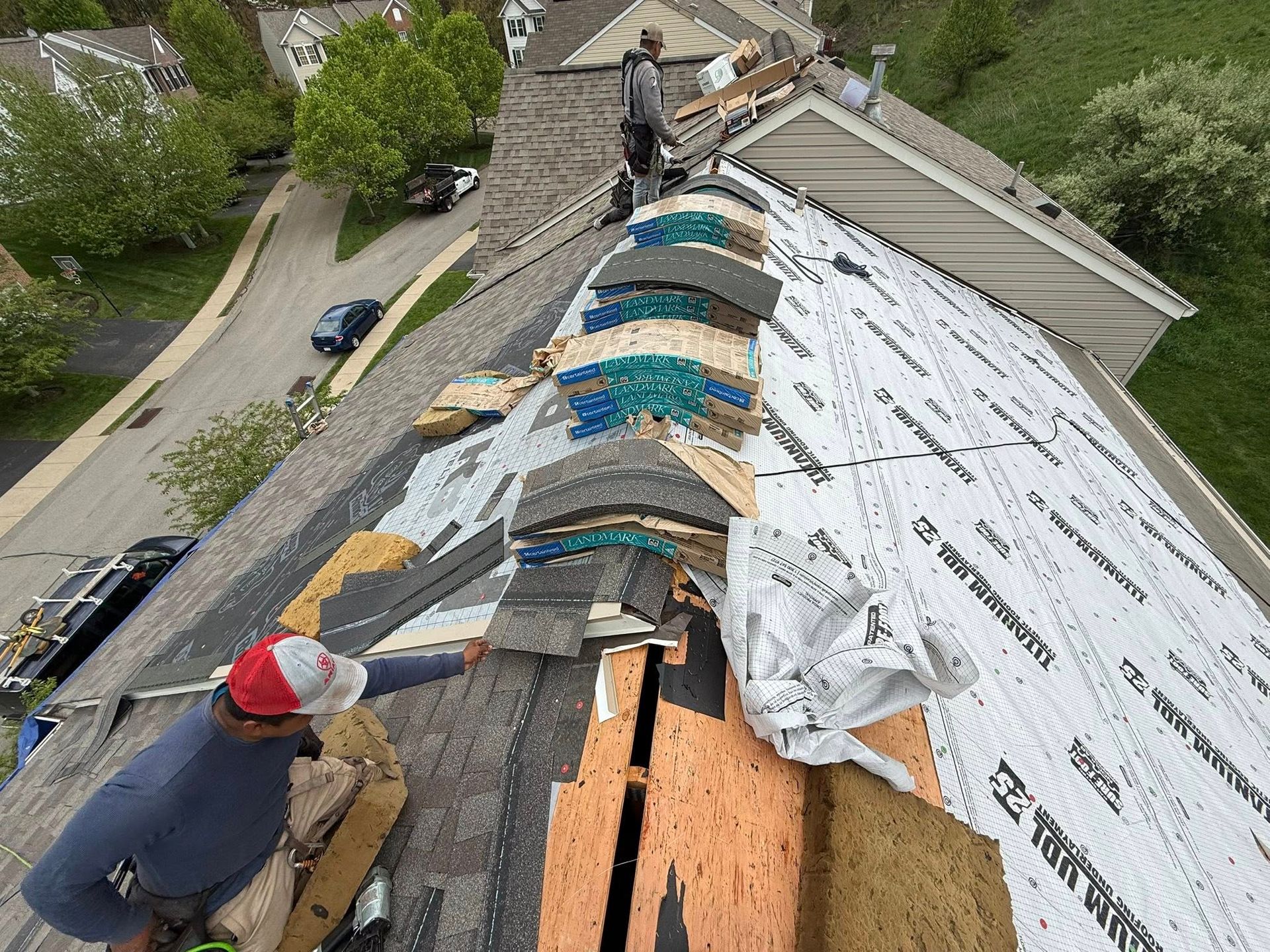 A man is working on the roof of a house.