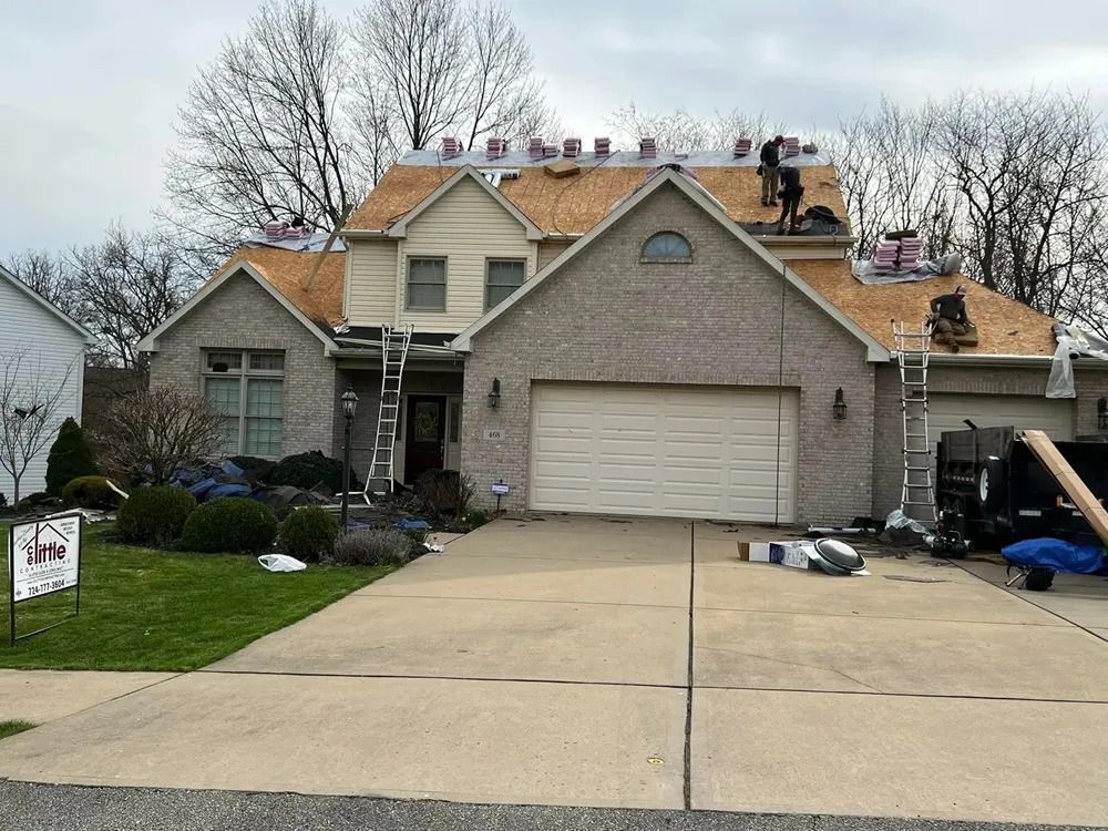 A house is being remodeled with a new roof being installed.