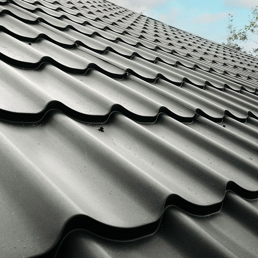 A close up of a roof with a blue sky in the background