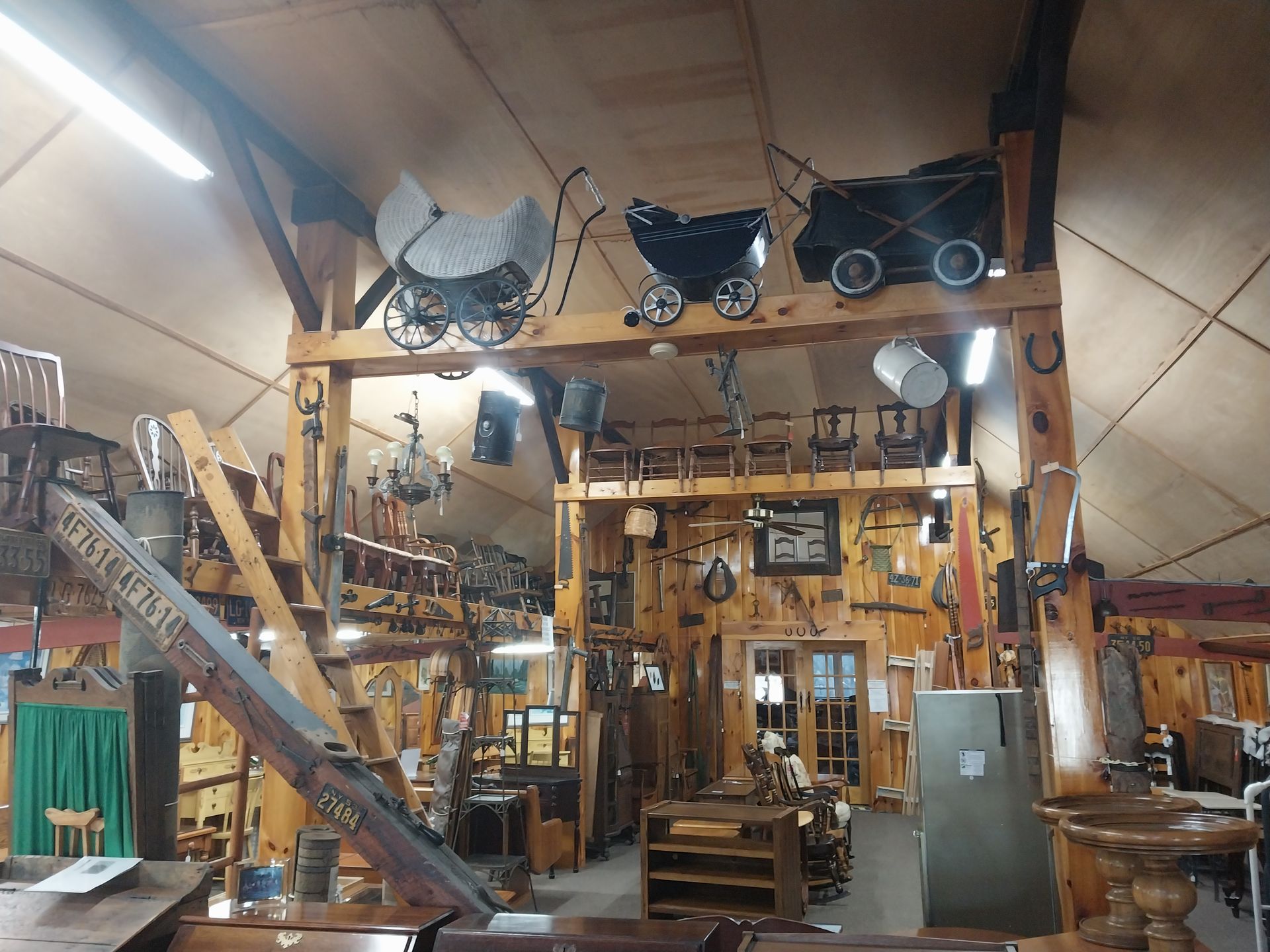 A room with a stroller hanging from the ceiling