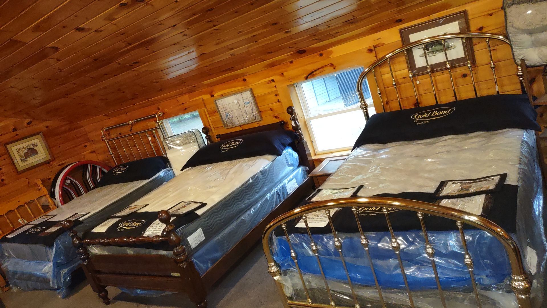 Two beds in a room with a wooden ceiling