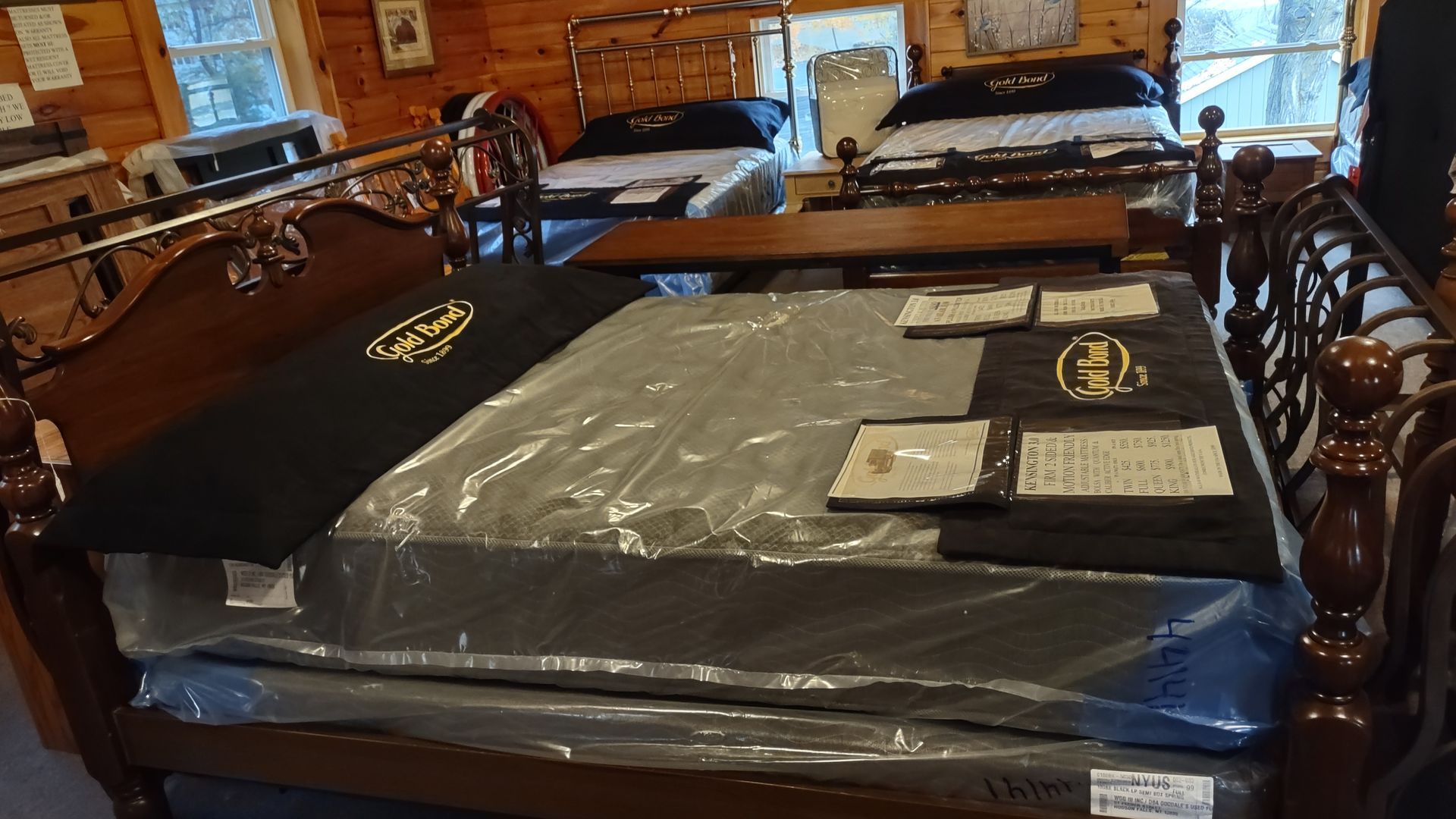 A bed with a mattress on top of it in a store.