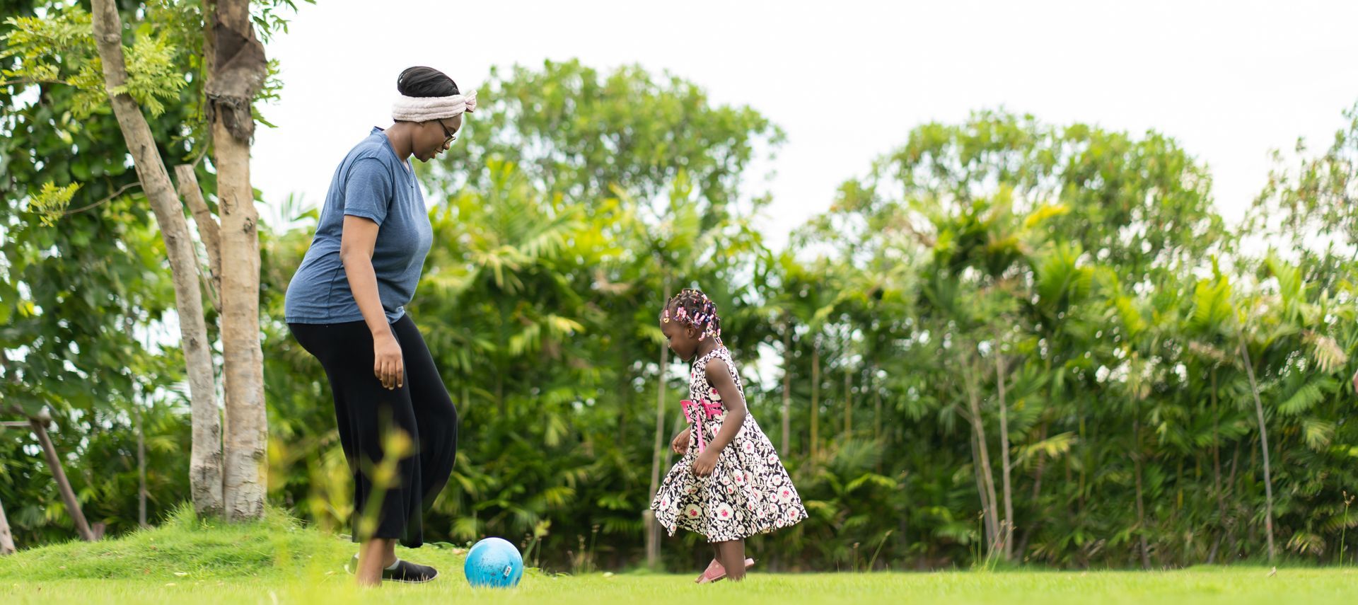 caregiver playing with child outdoors Trinidad childcare support