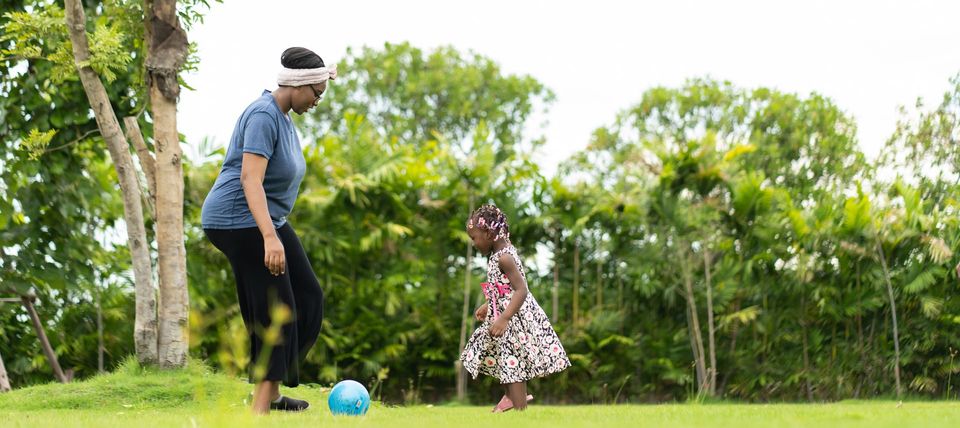 caregiver playing with child outdoors Trinidad childcare support