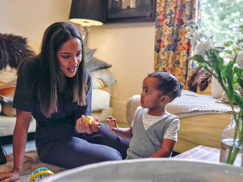 caregiver engaging with child at home childcare setting