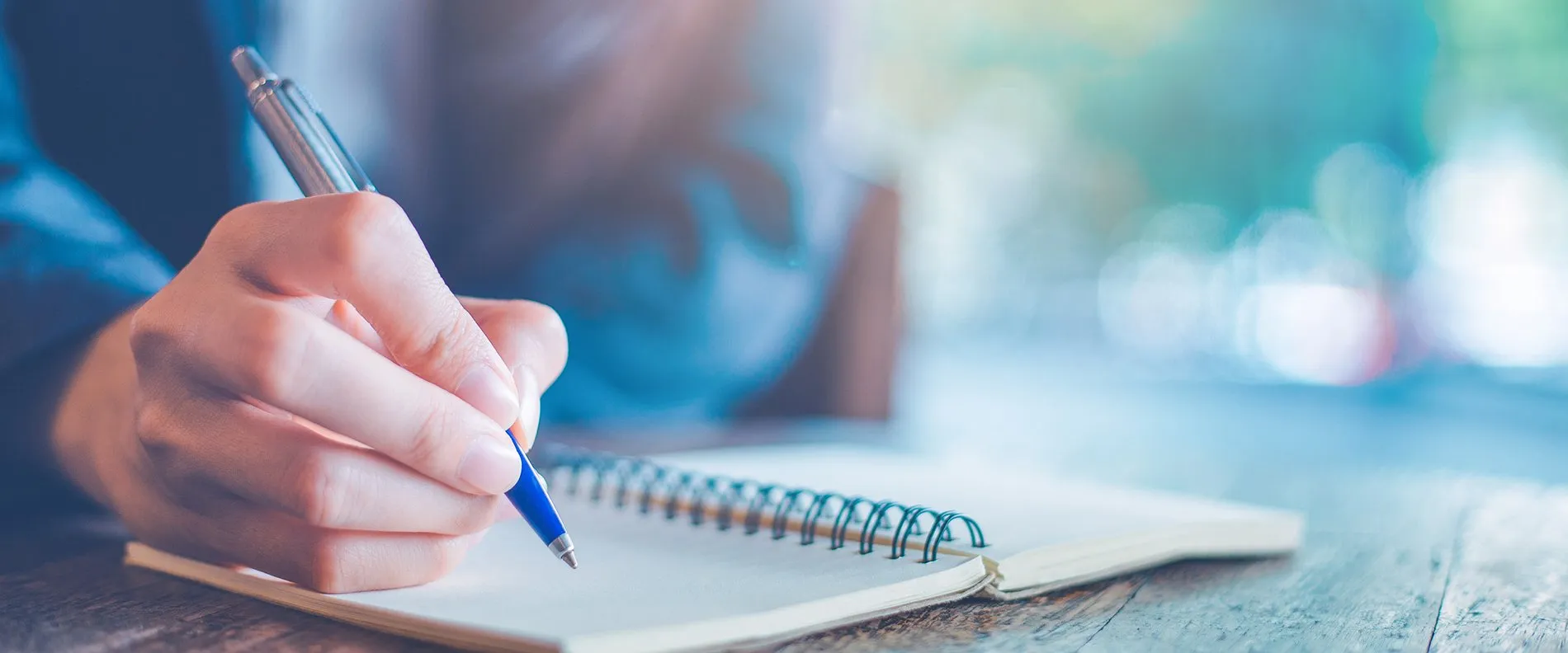 person writing in a notebook