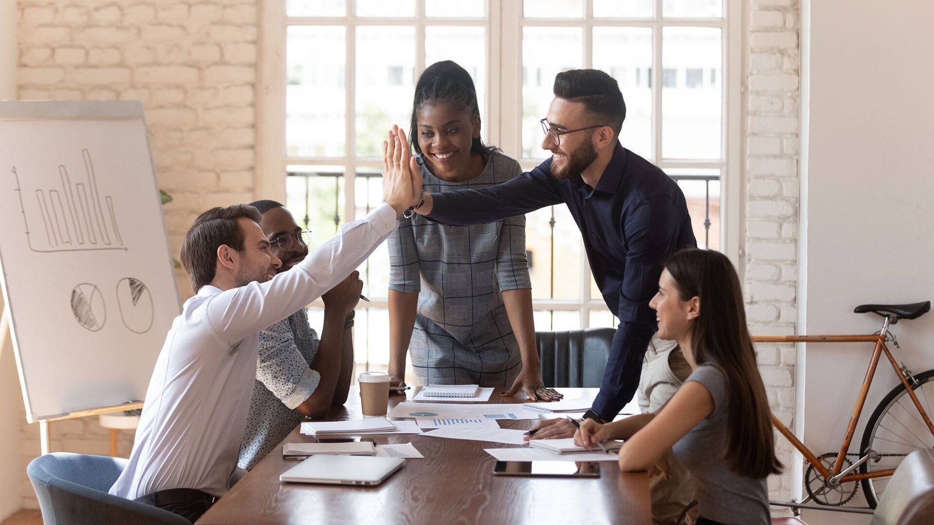 Woman in blue leading business meeting
