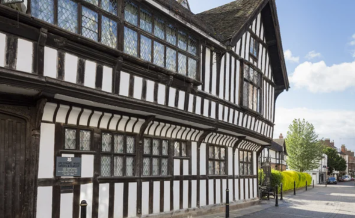 It is a black and white building with a lot of windows. National trust work