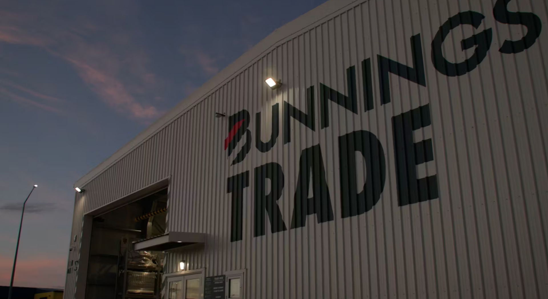 Bunnings Trade store exterior with large logo, dusk setting.