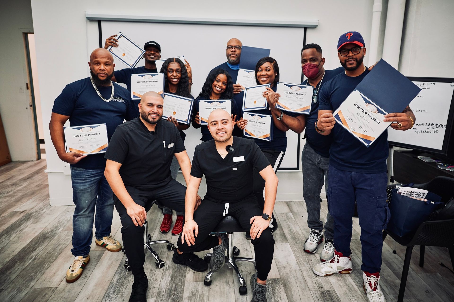 A group of people are posing for a picture while holding certificates.