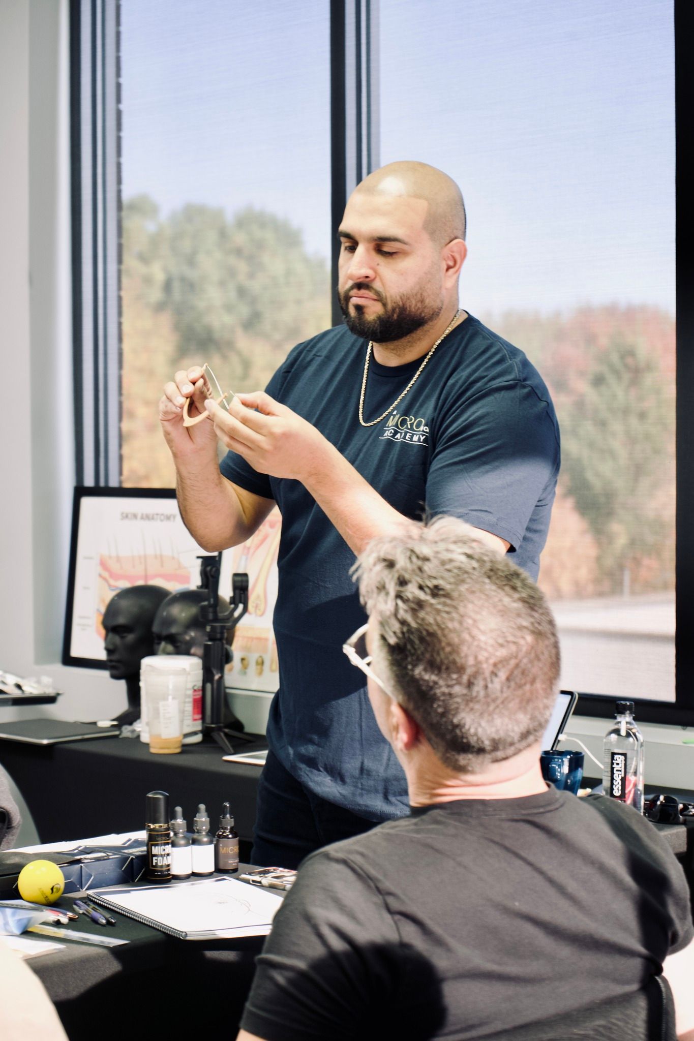A man is giving a presentation to a group of people in a room.