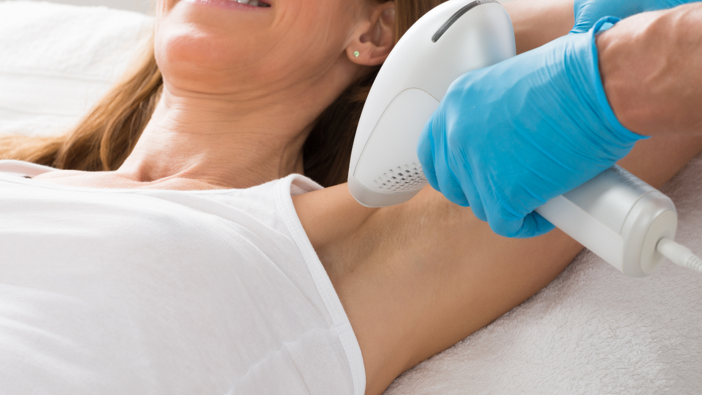 Person receiving underarm laser hair removal treatment.