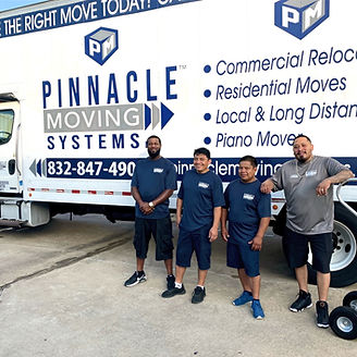 Four movers stand by a Pinnacle Moving Systems truck.