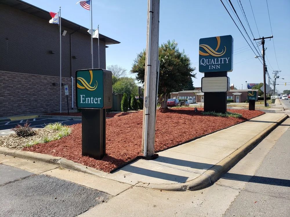 Entrance signs outside a building, including a green “Enter” sign and an “Occupancy” sign by the sidewalk.