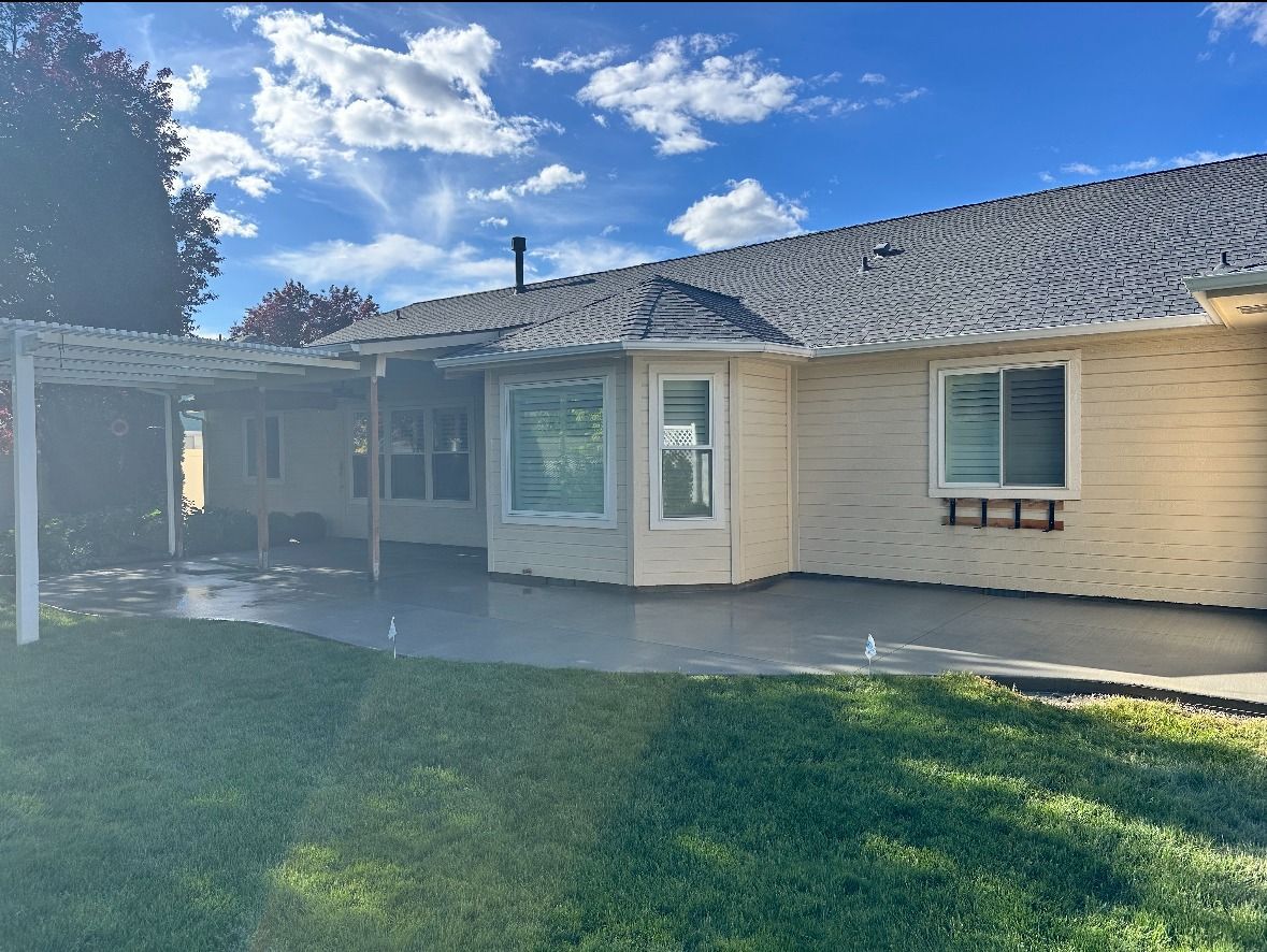 The back of a house with a patio and a pergola.
