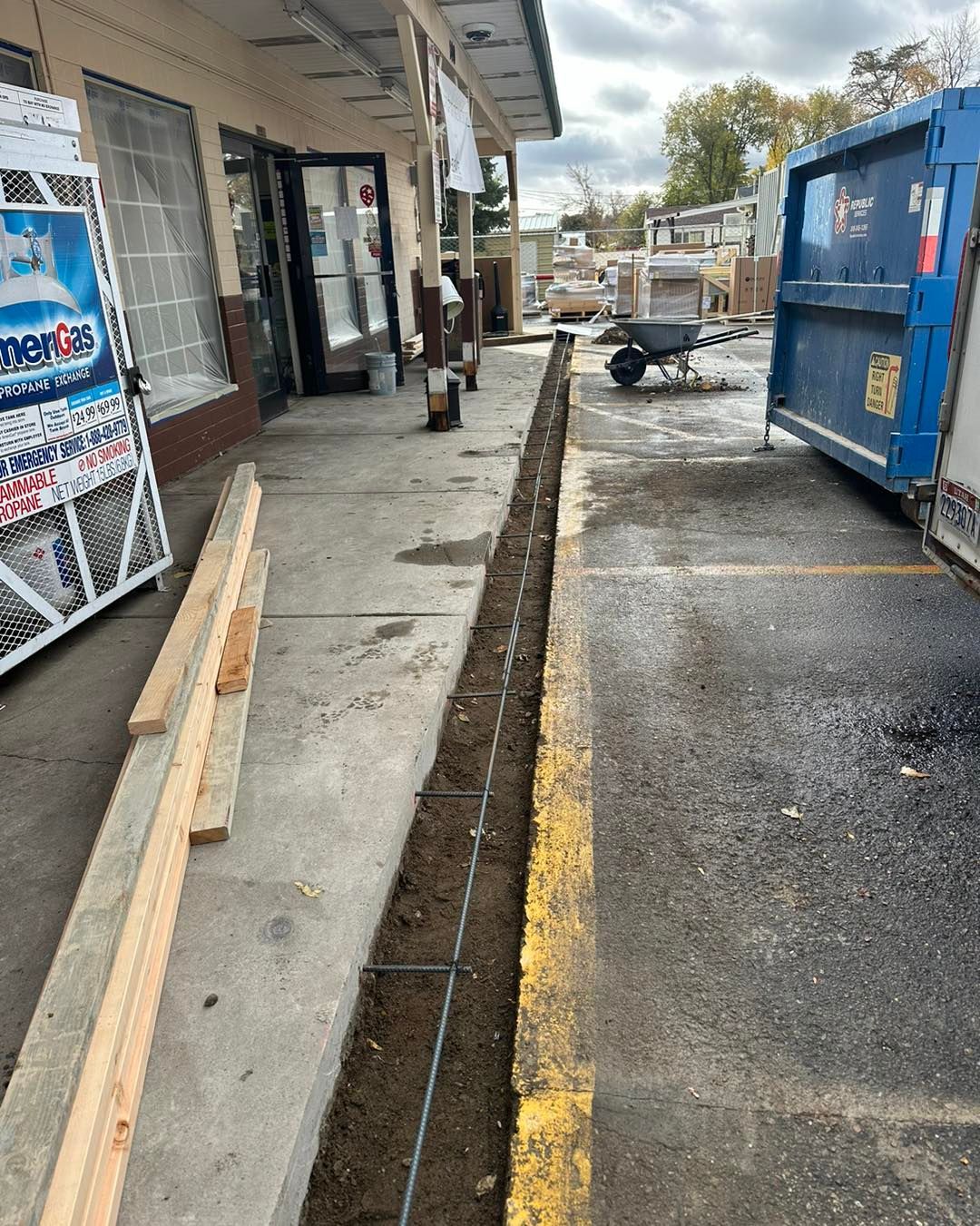A concrete walkway is being built in front of a building.