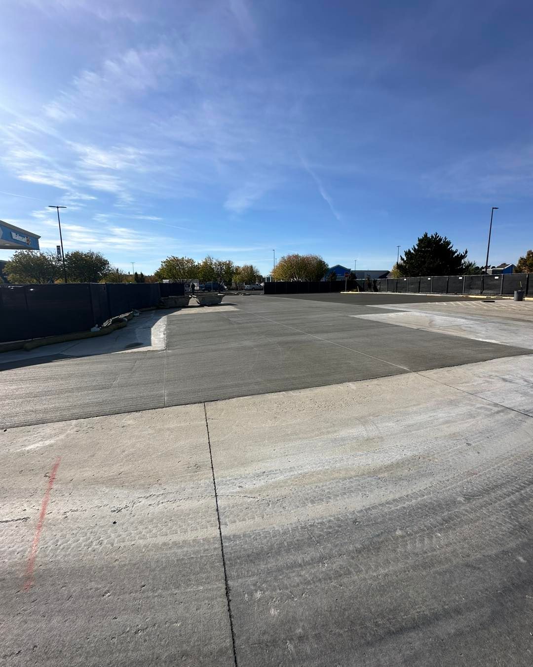 An empty parking lot with a blue sky in the background