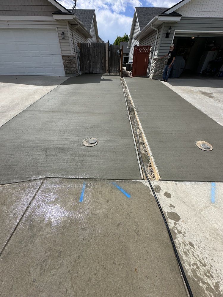 A concrete driveway is being built in front of a house.