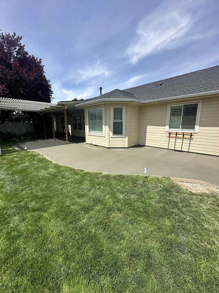 A house with a concrete patio in front of it.