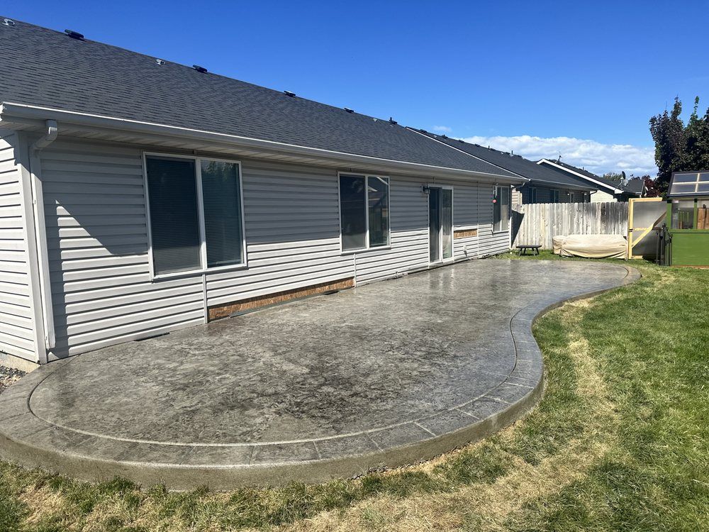 A house with a concrete patio in front of it.