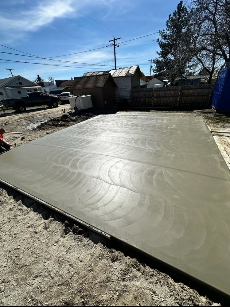 A concrete driveway is being built in a backyard.