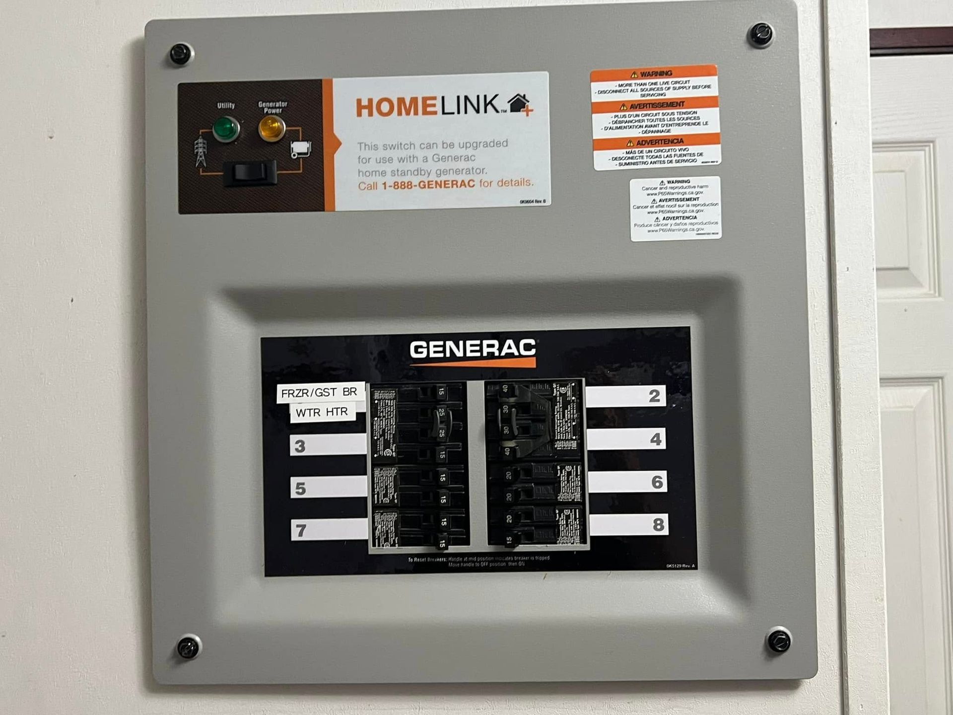 Generac HomeLink automatic transfer switch panel on a wall with switches and labels.