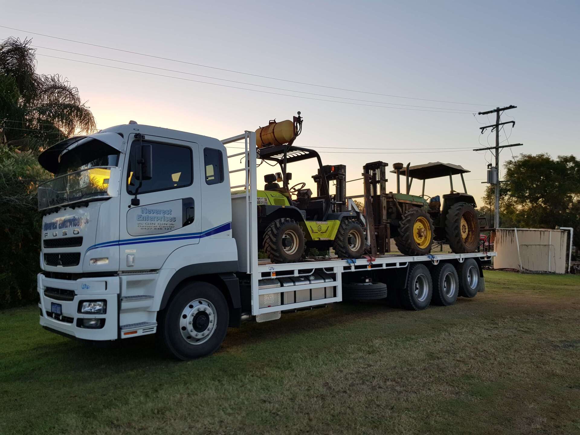 Truck Carrying Two Tractors — Deliveries in Gin Gin, QLD