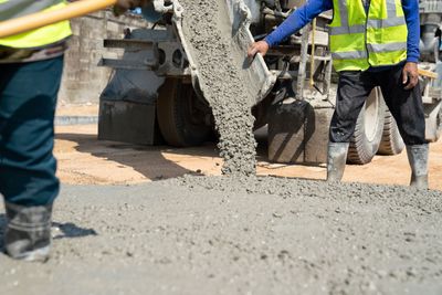 Aloha Concrete Pros contractor supervising a concrete pour, highlighting expertise in concrete repair, concrete crack repair, and driveway repair services.