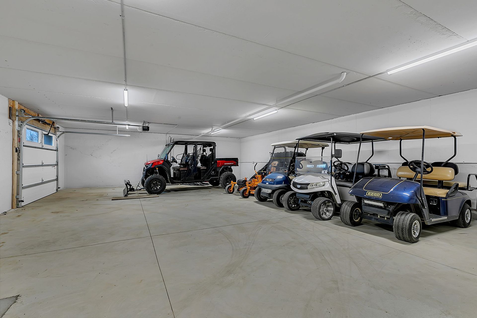 Garage with utility vehicles and golf carts.