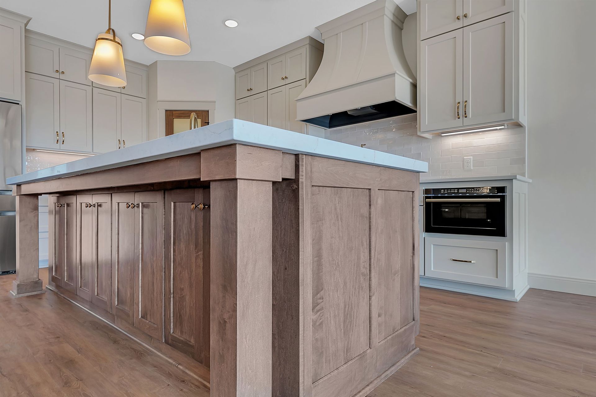 Kitchen with wood island, white cabinets, and stainless steel appliances.