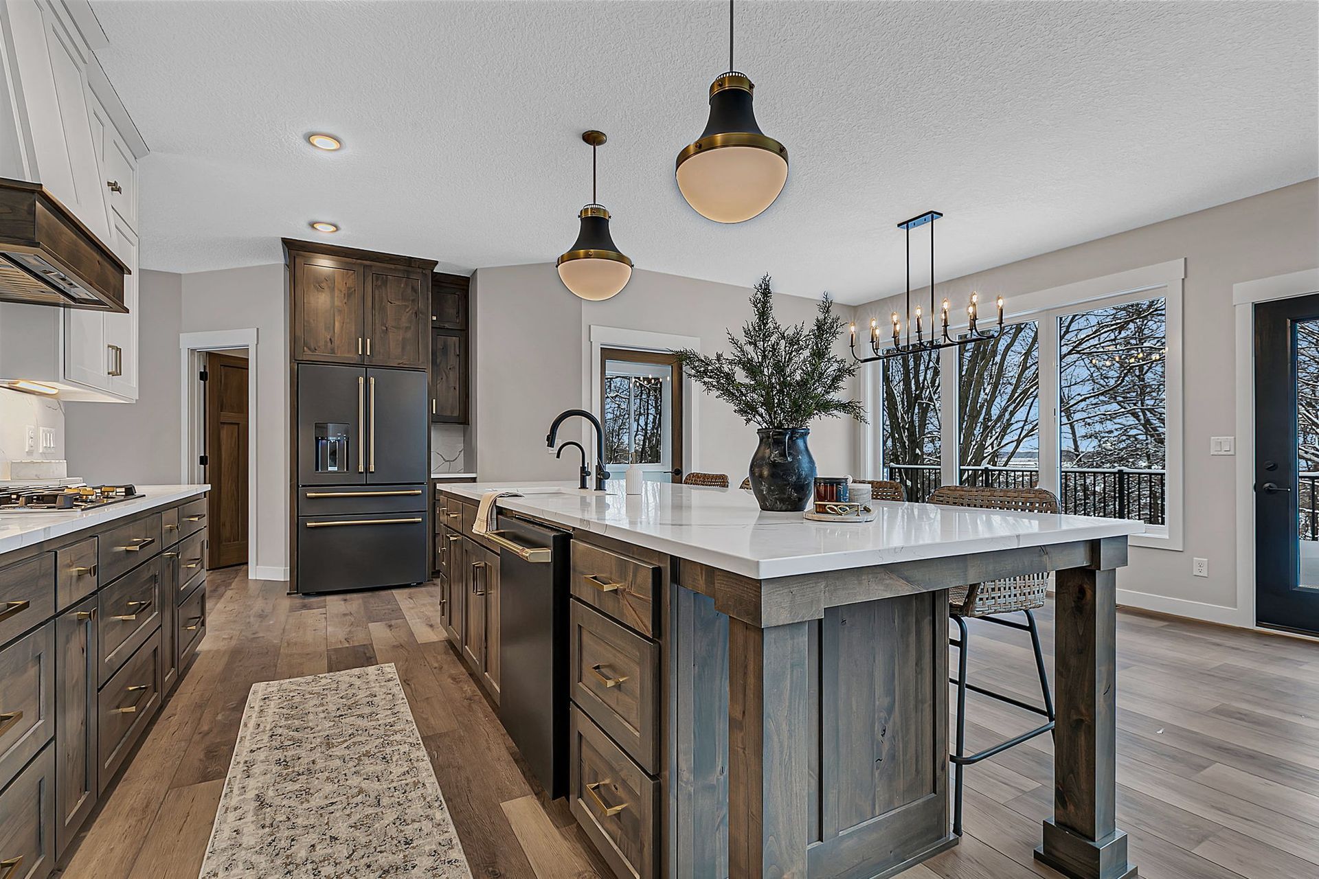 Modern kitchen with wood cabinets, island, and large windows.