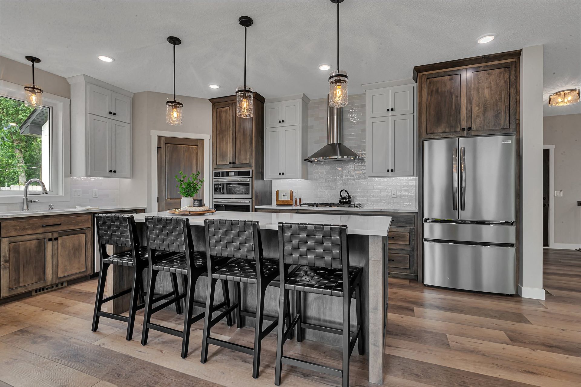A kitchen with stainless steel appliances , wooden cabinets , and a large island.