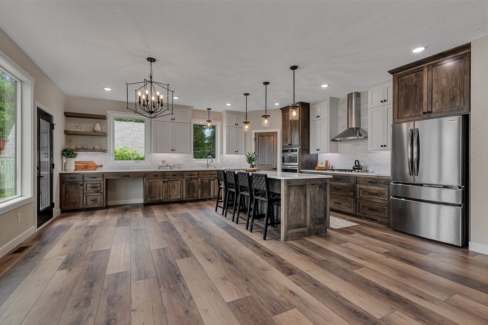 A large kitchen with hardwood floors and stainless steel appliances.
