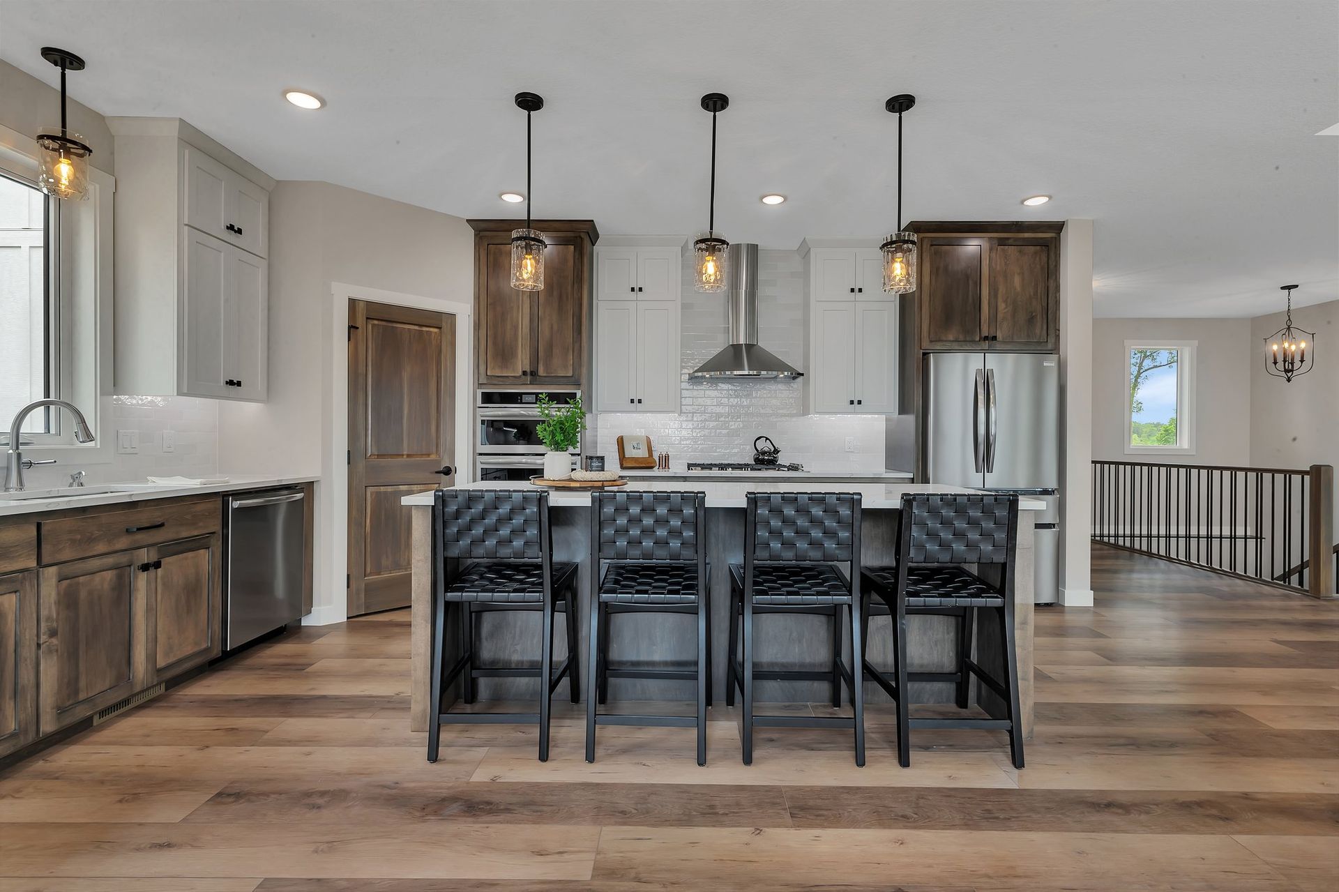 A kitchen with a large island and stools
